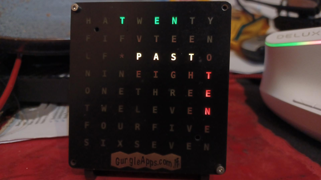 Clock showing TEN PAST TEN past Ten in green, yellow and red