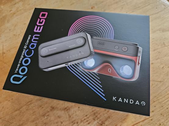 The front of the box for the Kandao QooCam Ego digital 3d camera. it has a picture of the camera, as well as the attachable 3d viewer.