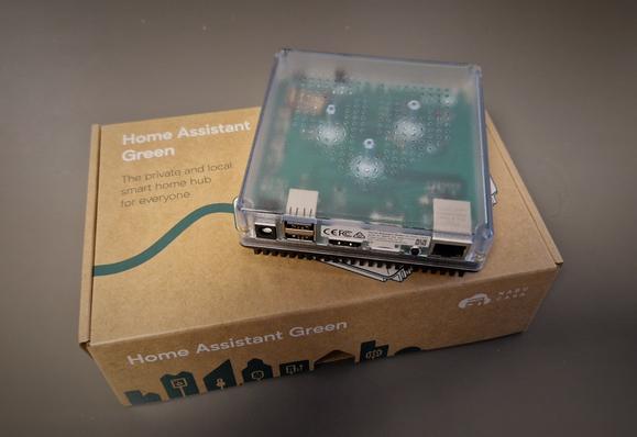 A Home Assistant Green device placed on the top of the box it arrived it.