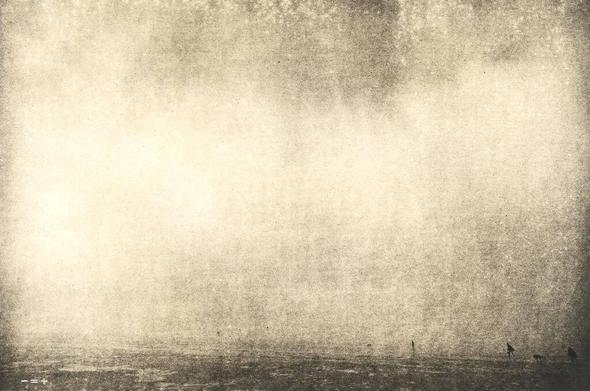 Shot of a foggy scene at the Northe Sea with people and a dog in the lower right. Lithprint.