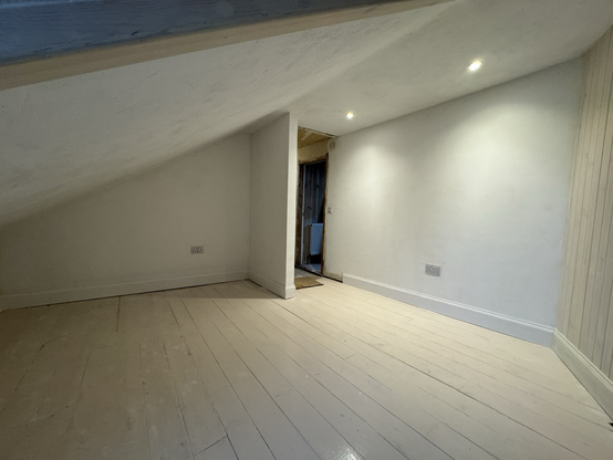 Attic room with lime plastered walls and timber floor