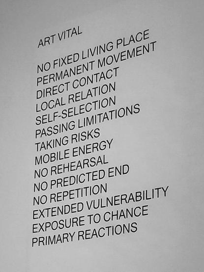 List on a wall that says
Art vital
No fixed living space 
Permanent movement 
Direct contact 
Local relation 
Self-selection 
Passing limitations 
Taking risks 
Mobile energy 
No rehearsal 
No predicted end
No repetition 
Extended vulnerability 
Exposure to chance
Primary reactions