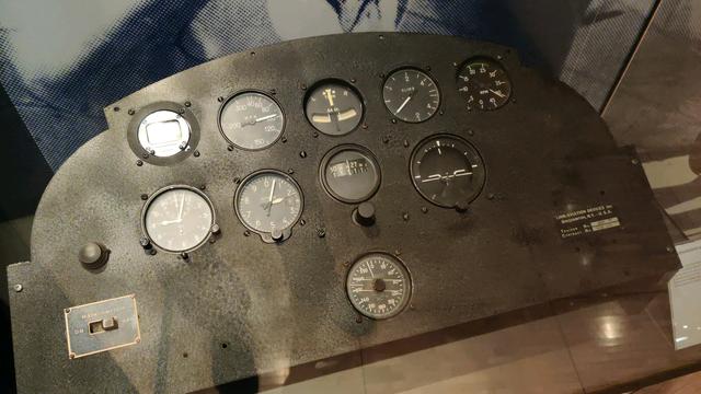 The instrument console of a WWII-era fighter aircraft. Compass, speed, bank/turn indicator, climb rate, engine RPM, clock, altimeter, heading, artificial horizon and (maybe) yaw indicator. The readings on all dials were provided by an analog computer.