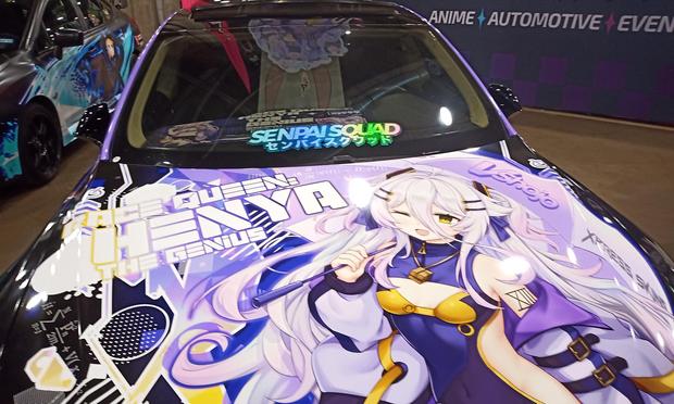 Henya the VTuber decorated and wrapped car on a showroom floor at Weebcon in Dallas, Texas.