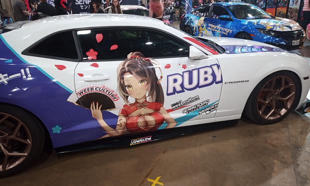 Ruby the VTuber decorated and wrapped car on a showroom floor at Weebcon in Dallas, Texas.