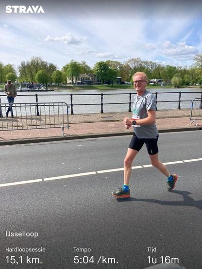 Runner on the road next to river IJssel during IJsselloop today