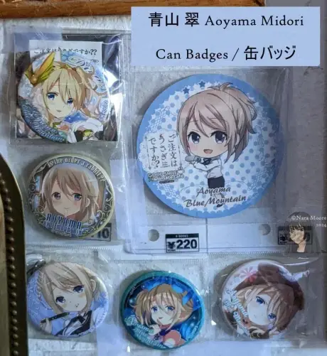 5 Midori Blue Mountain can badges and one coaster.