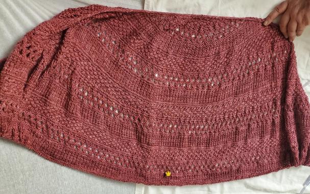 Long shot of shawl laid out on the hospital bed