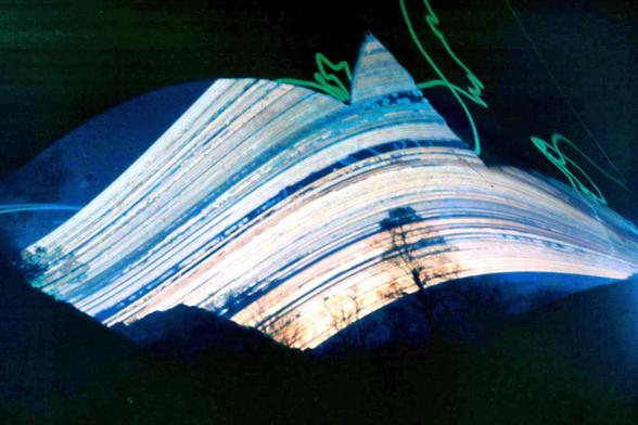 Long term exposure of the sky, showing the traces of the sun over one year over a mountain panorama.