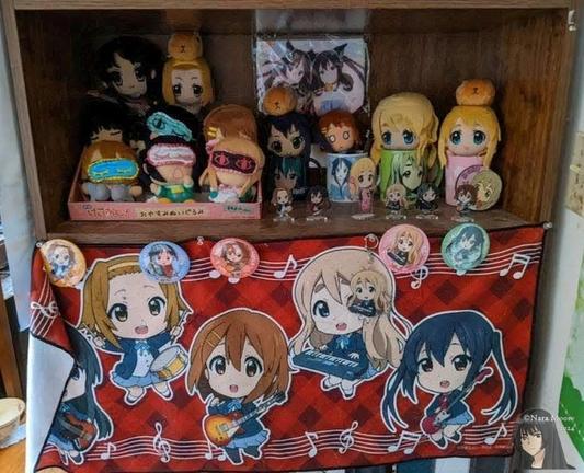 KON! Plushies, mugs, towel, can badges, and standees