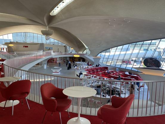 The central atrium of the old TWA terminal at JFK. Very very 60s modem organic shapes as far as the eye can see. Everything is white with red accents, upholstery, and carpet.