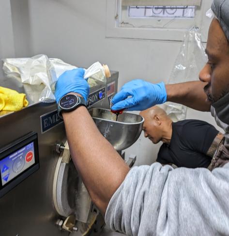 A Mitchell's employee making ice cream