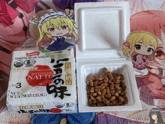 Mugi and Tohru stand by unopened and opened natto boxes.