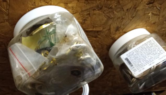 Originally air freshener jars, square, reused and attached to a ceiling in the workshop. My collection of badges and buttons from my former military life