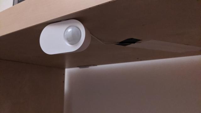 Motion sensor with a wire coming out of the back of it