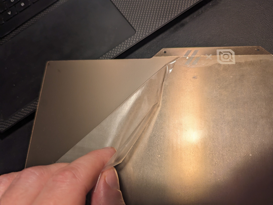 The protective film on the smooth PEI side of the build plate that we are supposed to remove and which I did not notice