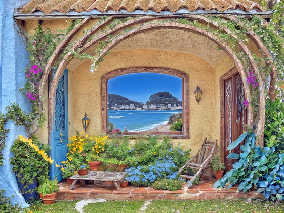 Cottage patio workroom with tan plastered walls and an arched window portal leading to the picturesque beach of a vacation planet. Flowers and plants add a splash of color to the cozy space, while a wooden chair invites one to sit and enjoy the atmosphere.