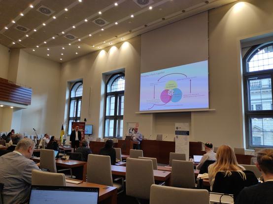 the Sitzungssaal of the town hall with the keynote speaker at the the lectern