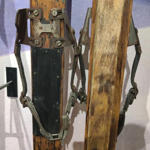 A close up of the bindings on an antique ski from the 1930s
