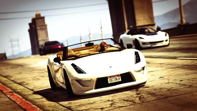 A screenshot I took in the video game GTA Online using the Rockstar Online. It shows my female character driving a Grotti Carbonizzare over a bridge followed by two other sports cars.