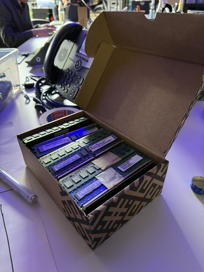 Box full of RAM bars for computers of various types, mostly with 10 year and older specifications.