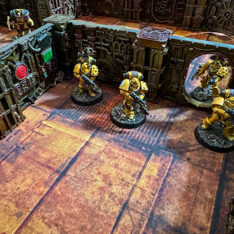 An Imperial Fists squad breaching a door in the underhive