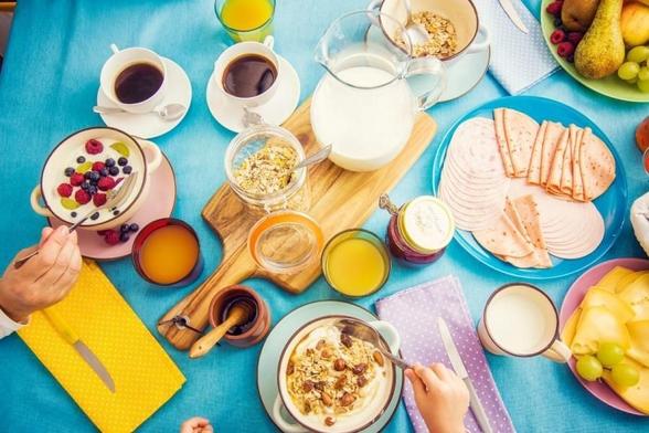 Healthier Belgian breakfast with cereals, fruit, cheese and deli meats.