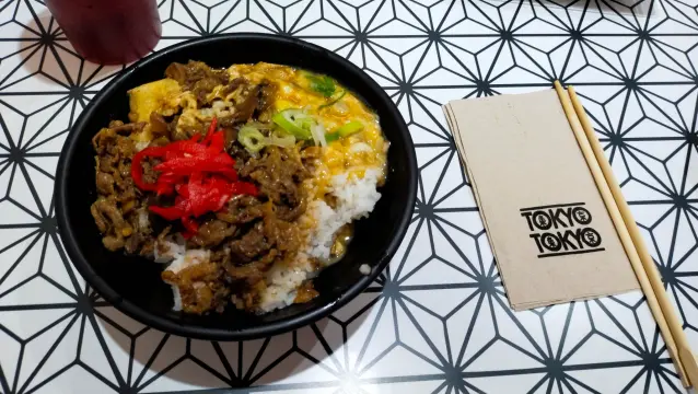 Beef Gyudon rice bowl, with a Tokyo Tokyo-branded tissue to the right with chopsticks on top