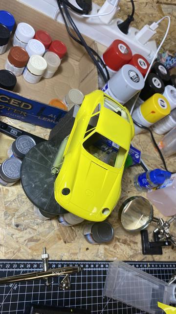 Yellow painted bodywork of a Porsche 911 GT2 Clubsport by Tamiya in 1:24 on a workbench.