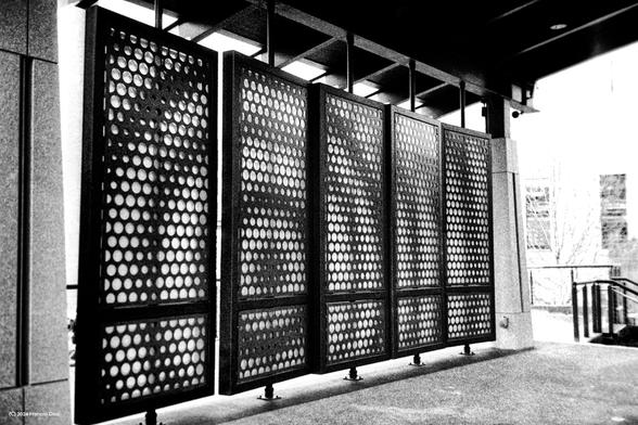 Little shelter in Bailey Park. The back wall has concentric circle patterns and each panel is full of holes arranged to make this visual impression