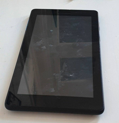 A dirty, scratched and chipped Lenovo tablet.