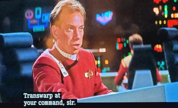 Miguel Ferrer as First Officer at the helm on a federation ship. Subtitles read Transwarp at your command, Sir.