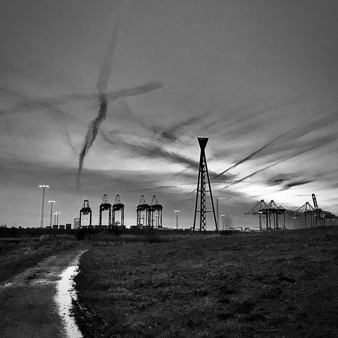 A black and white photo of the container terminal 4 Bremerhaven at dusk.