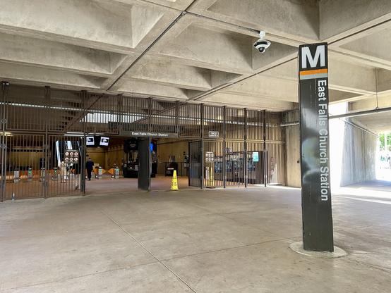 Entrance to a Metro station with a pylon reading East Falls Church Station on it