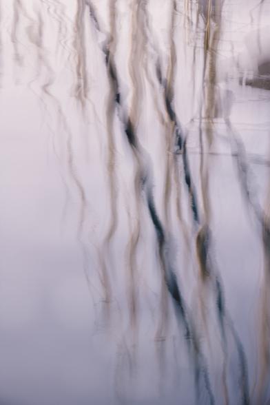 Here the use of soft colors and intentional camera movement gives some boat mast reflections an ethereal and dreamlike quality.