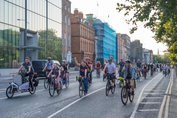 Large group of people cycling bikes together