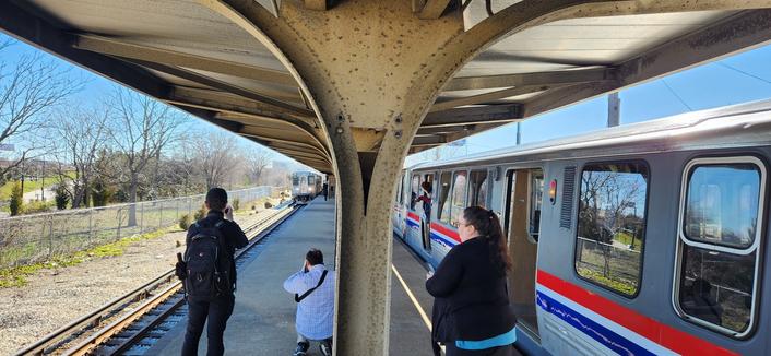 Photo taken on the Central Ave station on the CTA Blue Line Congress Branch. On the left is an incoming Forest Park bound train. On the right is an eastbound CTA vintage train.