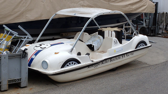 A pedal boat where the upper half is designed like a VW Beetle in Herbie-style livery, i.e. white with a blue and red stripe on the hood and the racing number 53. (No doors and the roof is more like a boat's canvas sunroof between two aluminium arches.)