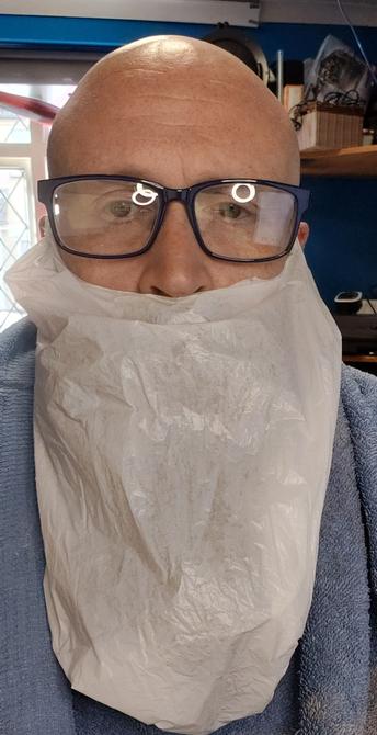 Me, wearing blue glasses. I'm wearing a plastic bag over my beard hanging from my ears.