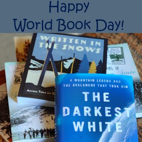 A pile of snowsports related books and the caption "Happy World Book Day!"