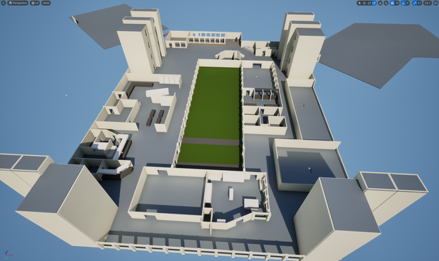 An overhead view of a level in Unreal Engine 5 that shows progress on designing the first floor of a large building. Some structures tower up in the screenshot: these are stairwells and elevator shafts.
