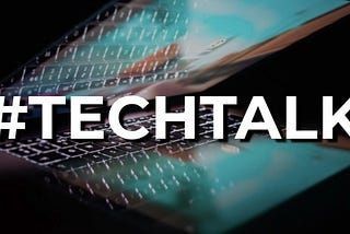 Decorative Image - bold white text: #TECHTALK over a stylised photo of a partially opened bright laptop screen