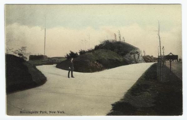 The image shows a vintage postcard depicting a scene of a road winding through a park-like setting. On the right side of the postcard, there is an illustration of a person in mid-stride walking away from the viewer along the path. The background features a grassy area with small trees or shrubs, and the sky above is overcast. At the top left corner of the postcard, the name "MERRITON" is written, suggesting it may be the location depicted in the image.

The style of the illustration is reminiscent of mid-20th century postcards, with a flat perspective and clear outlines that give the image an almost cartoon-like quality. The colors used are muted, with greens and grays dominating the palette, contributing to the vintage aesthetic of the artwork.