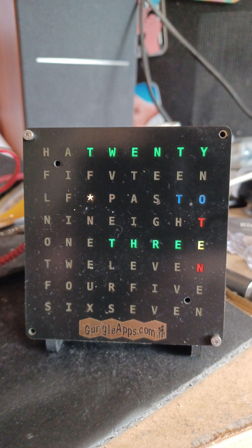 Time is 9:37
Clock reads
TWENTY THREE TO TEN

minutes are in green, TO is in blue and TEN is in red