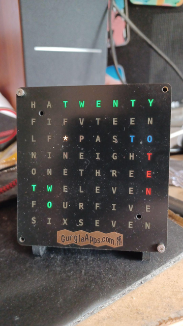 Time is 9:38
Clock reads
TWENTY TWO TO TEN

minutes are in green, TO is blue and TEN is red