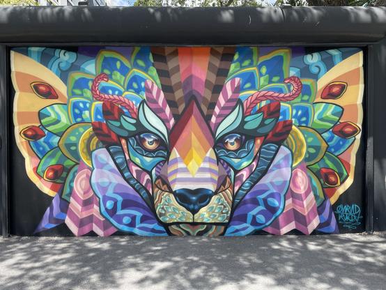 Colorful mural of a wolf with patterns in different colors all over it