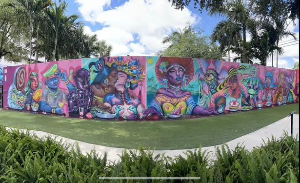 Panorama of a wide mural depicting various queer people and animals interacting with each other