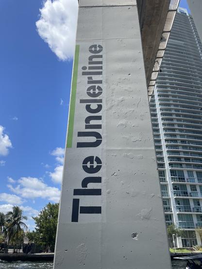 Square column with text printed on it reading “The Underline”