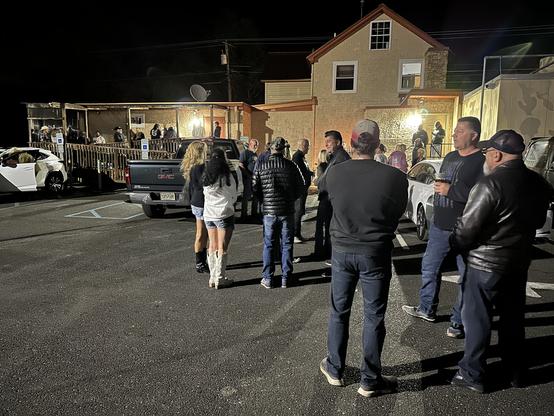 People standing outside The Golden Nugget Tavern in Berlin, NJ after having evacuated the building.