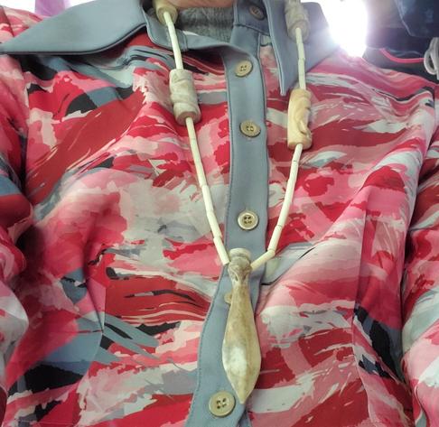 Wearing my custom necklace, made entirely from one deer antler. It has cormorant, eagle, raven, otter, orca, bear spirit animals represented. A paddle pendant with cormorant - the other spirit animals are handcarved large beads.
